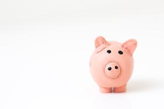 pink pig figurine on white surface by Fabian Blank courtesy of Unsplash.